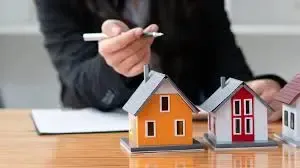 Blogs Packed With Expert Marketing Strategies for Home Builders 20 Person pointing to small house models on a table representing home builder marketing strategies